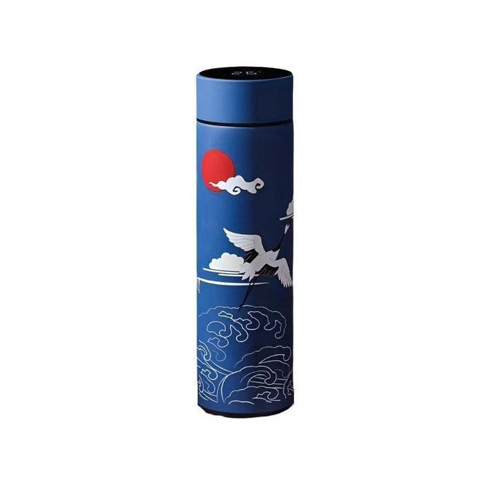 A tall, cylindrical thermos with a blue body, adorned with illustrations of flying cranes and ocean waves. The lid, placed next to the thermos, displays a digital temperature reading of 19°C.