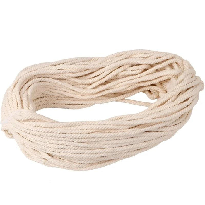 A coiled bundle of thick natural cotton rope, showcasing its clean and uniform weave. The rope appears to be of a sturdy, durable quality, suitable for various heavy-duty applications.