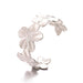 Silver cuff bracelet with a floral design, displayed on a white background.