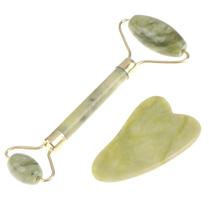 A jade roller and gua sha tool, both made from green jade stone, with golden handles.