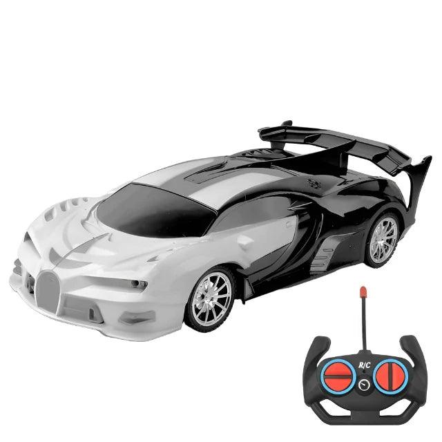  A shiny gray and black sports car with black accents and an accompanying remote control. The car features a sleek, aerodynamic design and large rear spoiler.