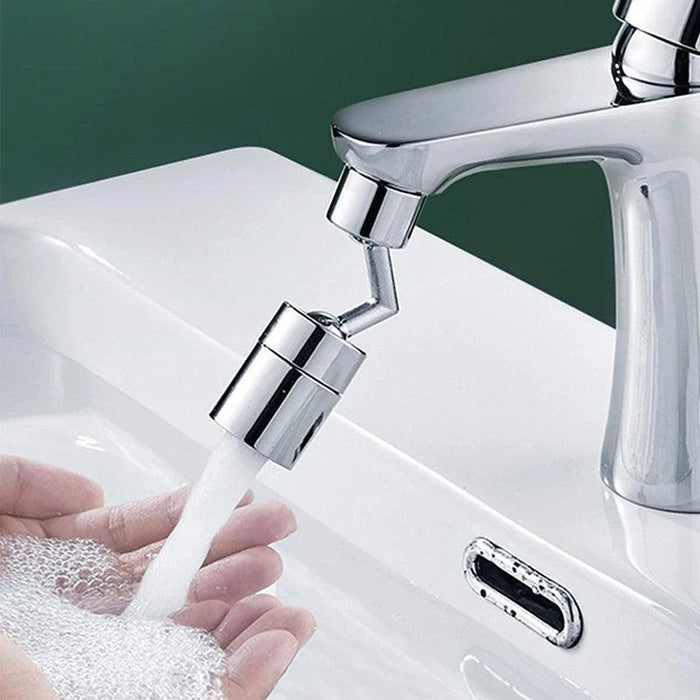 A faucet sprayer attachment releasing a gentle stream of water over hands being washed in a bathroom sink.