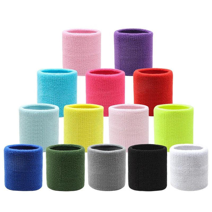 A collection of terry cloth wristbands in a variety of colors, arranged in three rows, with colors including pink, purple, turquoise, yellow, red, blue, black, grey, green, and white.