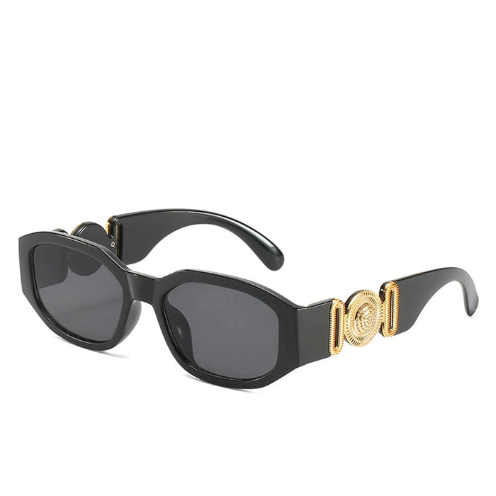 Black sunglasses with gold accents on the arms, showcasing the full frame and design, displayed on a white background.