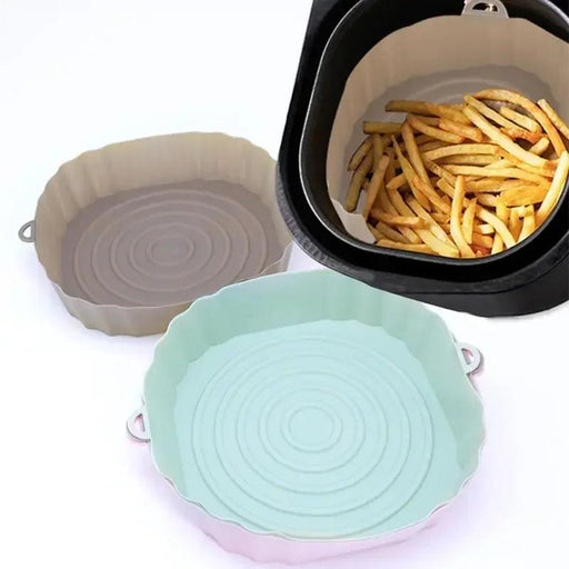 A collage showing three different silicone air fryer liners (beige, mint green, and pink) placed on a white background. The beige liner inside an air fryer basket is filled with french fries.