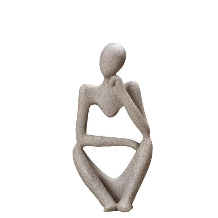 Sand color minimalist abstract sculpture of a figure sitting with one hand resting on the chin.