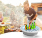 A man at a barbecue, using the collapsible wash basin filled with ice to chill beverages.