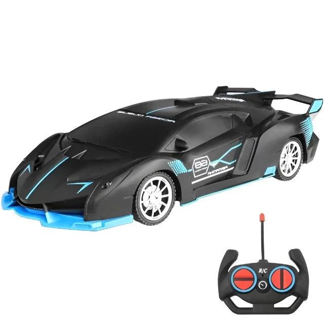 A black sports car with blue accents and an accompanying remote control. The car has a sleek, angular design and a large rear spoiler.