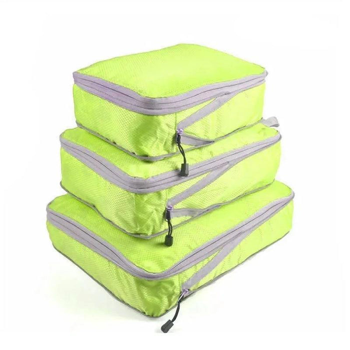 Three yellow packing cubes with gray zippers and handles, stacked on top of each other. Each cube has a zipper pull with a black tab.