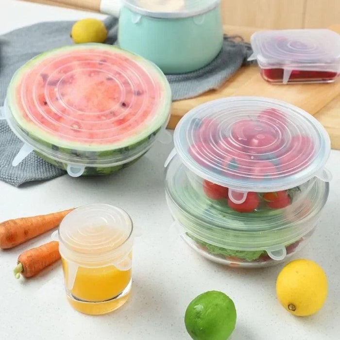 several silicone stretch lids covering various bowls and containers filled with food items like watermelon, salad, and juice, demonstrating their flexibility and airtight sealing capabilities.