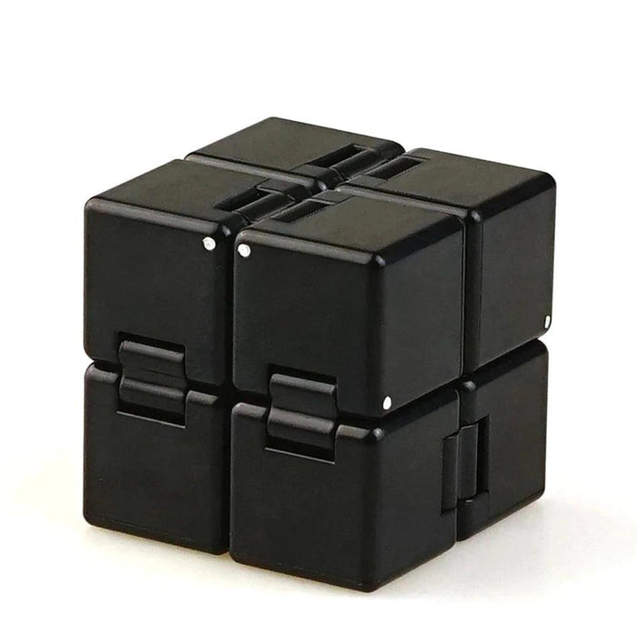 A close-up of a black Crazy Cube, showing its interlocking blocks and compact form.