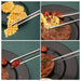 a set of stainless steel kitchen tongs in use, picking up various foods like waffles, corn on the cob, cherry tomatoes, and meat from plates.