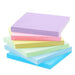 Vibrant adhesive note pads in a gradient of colors displayed in a spiral shape on a white background.