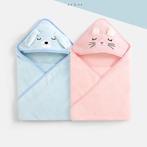 Two hooded baby towels laid flat. One is light blue with a dog face on the hood, and the other is pink with a cat face on the hood. Both towels have embroidered details and look soft and plush.