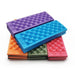 Stack of Foldable Foam Mats: A stack of foldable foam mats in various colors, including purple, blue, orange, olive, and pink. Each mat has a textured surface with raised dots, and the mats are neatly folded, showing their compact and portable design.