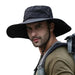 Man wearing a wide-brimmed black sun hat while hiking, with a backpack on his shoulders. The hat provides sun protection, perfect for outdoor activities such as hiking and camping.