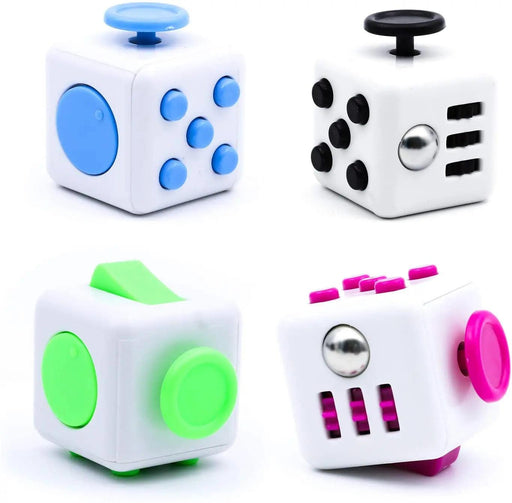 Four white fidget cubes with colored buttons and dials in blue, black, green, and pink.