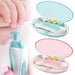 Pink and blue baby nail trimmer sets, each in an open case with five file heads, alongside a close-up of the trimmer being used on an infant's nail.