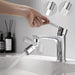 A hand adjusting a faucet handle with a faucet sprayer attachment, showing the spray and stream modes in the inset.