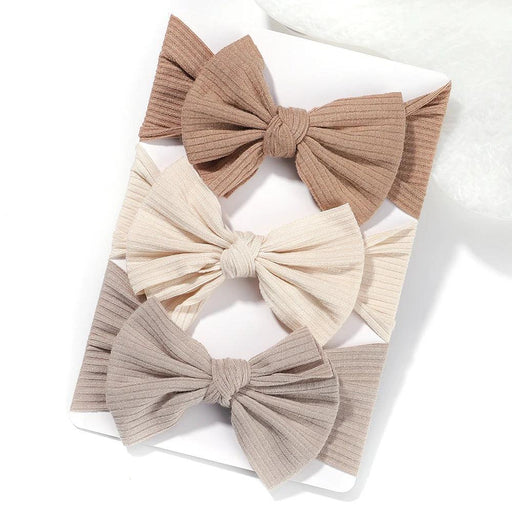 A set of 3 Baby Bow Headbands with different colors.