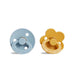 A round, blue pacifier with a ring handle next to a yellow, flower-shaped pacifier with a ring handle.