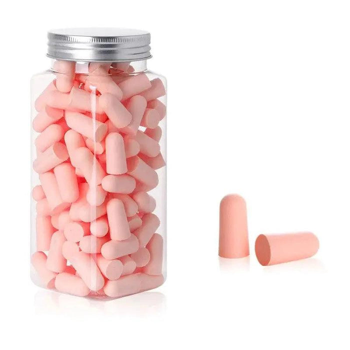 A jar filled with pink earplugs. With 2 pink earplugs beside it.