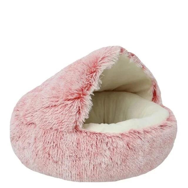 An empty fluffy pet bed, this time in a light pink color.