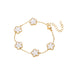 A gold bracelet, designed with a flower-shaped pendant with a white center.