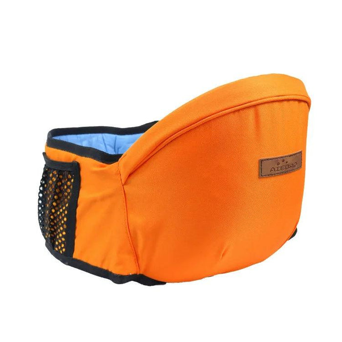 A vibrant orange baby waist carrier with a black mesh pocket and brown label tag, adding a pop of color to baby carrying essentials.