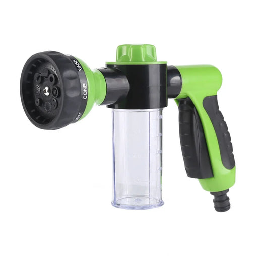 A green and black hose nozzle with a clear soap dispenser, displayed on a white background.