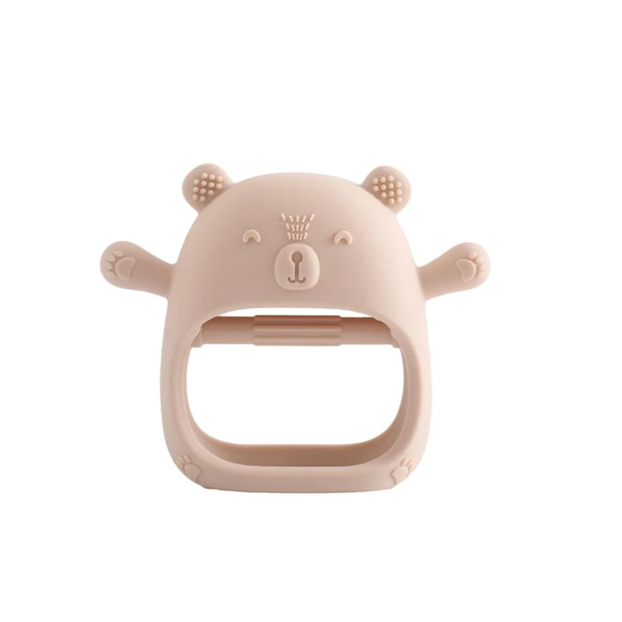 A close-up of a light pink silicone teether shaped like a bear, shown in front view on a white background.