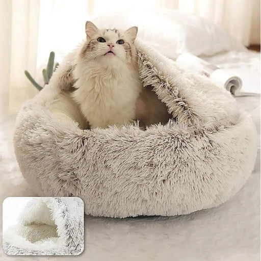 A light grey fluffy pet bed with a dome-shaped opening. The photo shows a cat peeking out from the bed, looking upwards. An inset image shows a close-up of the bed's interior.