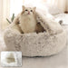 A light grey fluffy pet bed with a dome-shaped opening. The photo shows a cat peeking out from the bed, looking upwards. An inset image shows a close-up of the bed's interior.