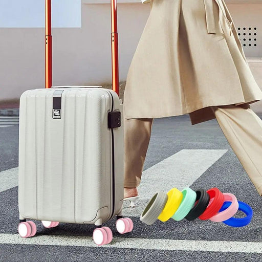 A person walking with a suitcase equipped with pink silicone wheel covers, with additional color options displayed beside the suitcase.