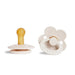 A beige pacifier with a yellow nipple and an ivory, flower-shaped pacifier with a ring handle.