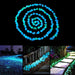 Blue and green glowing pebbles arranged in a spiral pattern, with three smaller images below showing glowing pebbles used to line paths and decorate outdoor spaces at night.