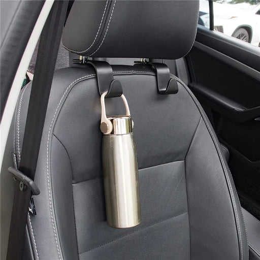 Headrest hooks holding a metal water bottle on a car seat.