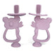 Two purple silicone teethers shaped like koalas with built-in toothbrush bristles on top.