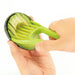 A person using a green avocado slicer to scoop and slice avocado flesh.