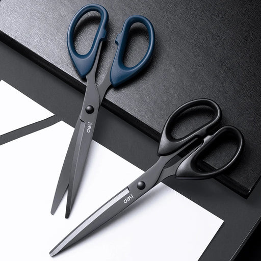 Two pairs of scissors, one with blue handles and one with black handles. They are displayed on a black surface with a white sheet, emphasizing their sharp blades and ergonomic handles.