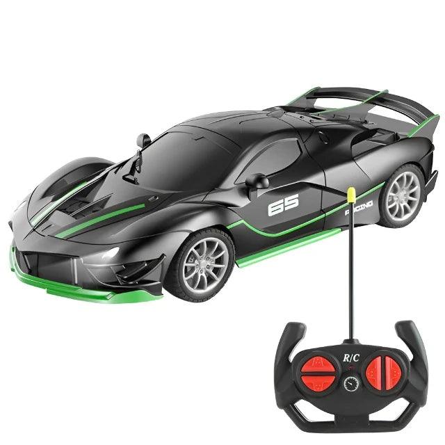 A black sports car with green accents and an accompanying remote control.