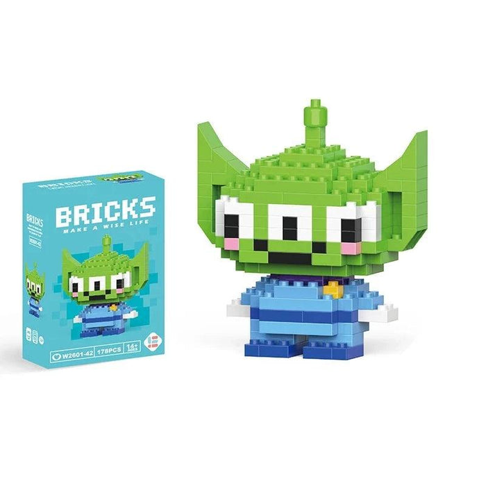 A single block-style toy figure of green alien, along with its blue packaging box. Display on white background.