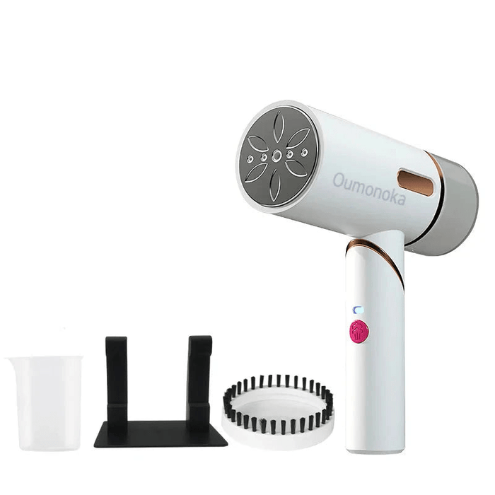 A white handheld garment steamer with accessories including a measuring cup, a stand, and a brush attachment.