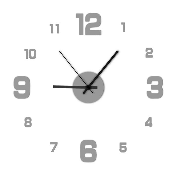 A wall clock with gray numbers and black hands, displayed on a plain white background.