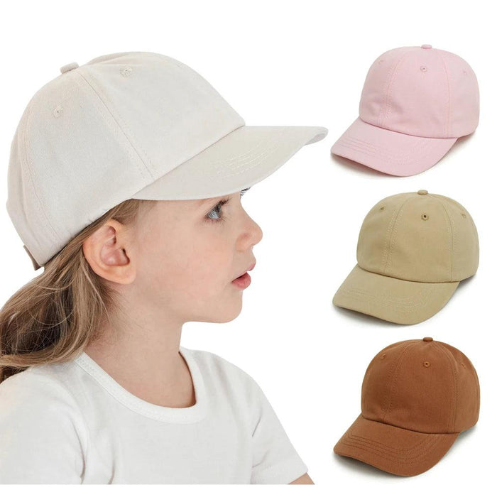 A young girl wearing a beige cap, with additional caps in pink, beige, and brown shown to the right.