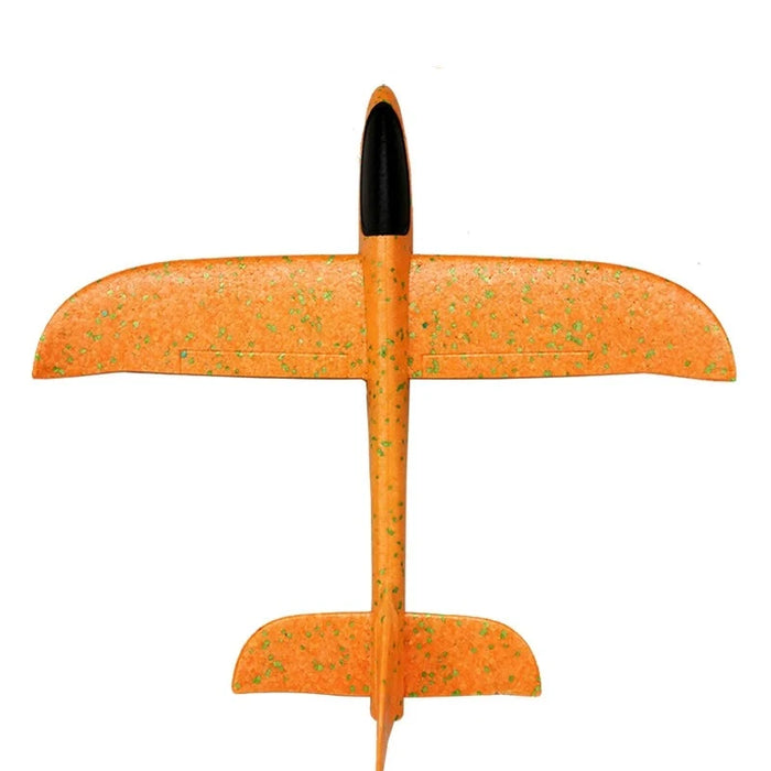 a top-down view of the fully assembled orange foam glider with orange speckles, emphasizing its simple yet effective design.