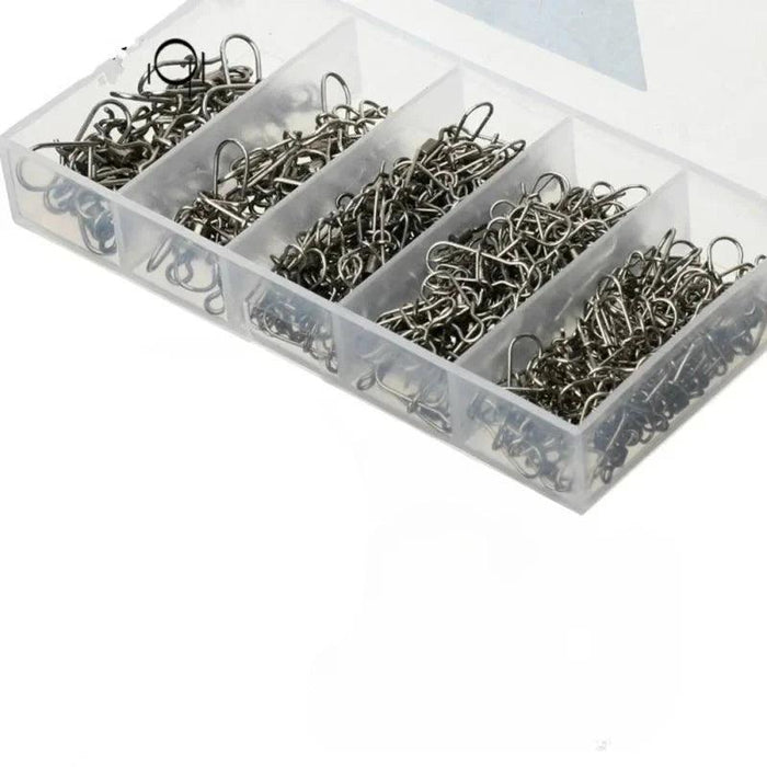 A plastic compartmentalized box filled with assorted fishing snap swivels, neatly organized by size.