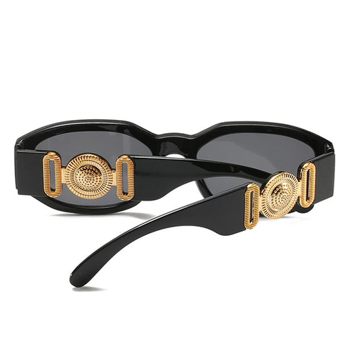 Back close-up of black sunglasses with gold decorative details on the arms, emphasizing the stylish design elements.