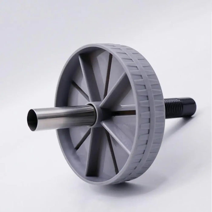 Close-up of a single grey ab roller wheel with a central metal rod, designed for abdominal exercises.