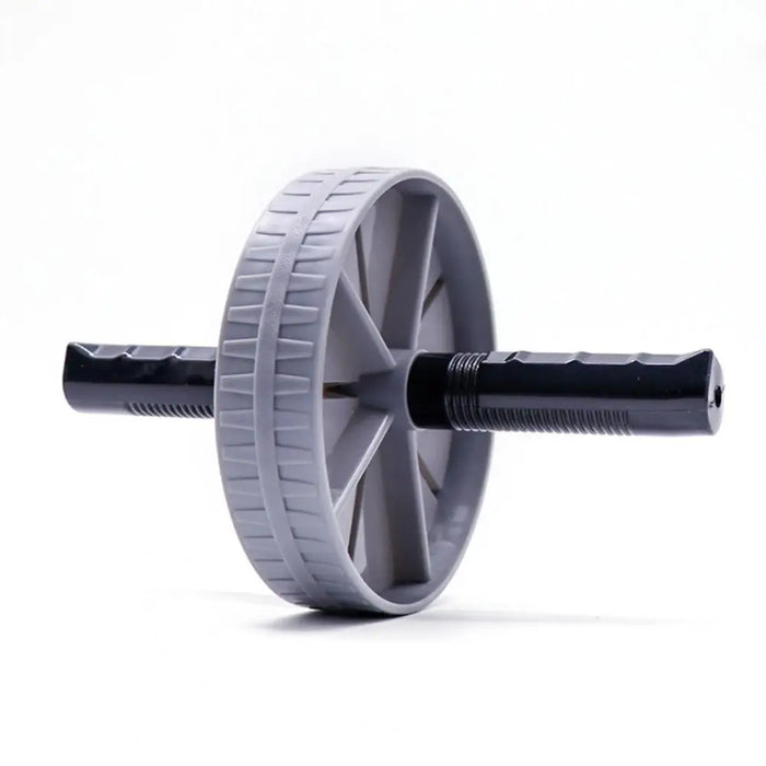 Angled view of the grey ab roller wheel, highlighting the textured surface of the wheel and the ergonomic grip handles.